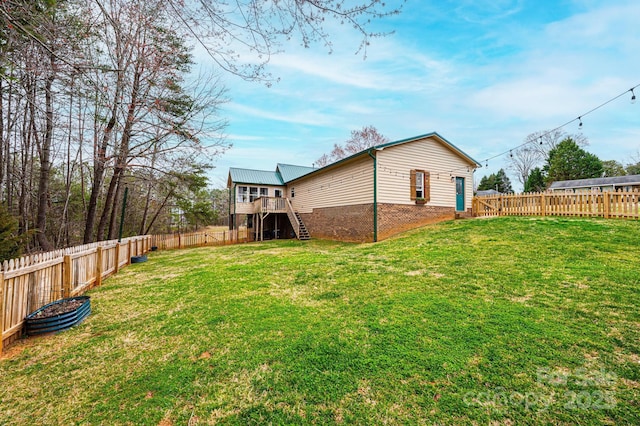 view of yard with stairway, a wooden deck, and a fenced backyard