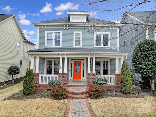 view of front of home with a porch and roof with shingles