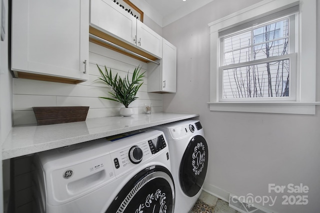 washroom with cabinet space and washing machine and clothes dryer