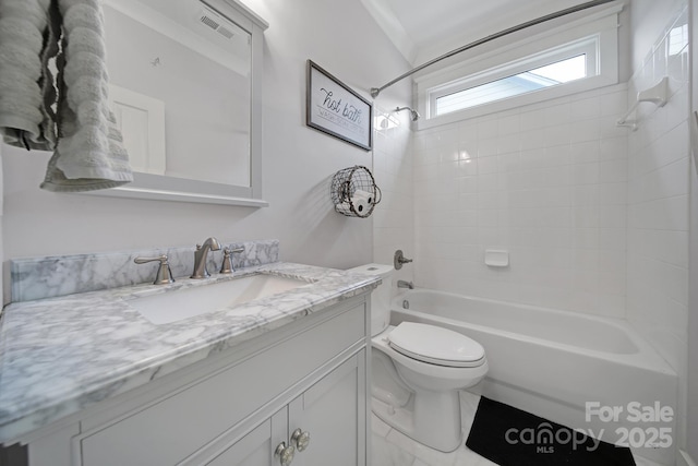 bathroom with washtub / shower combination, visible vents, vanity, and toilet