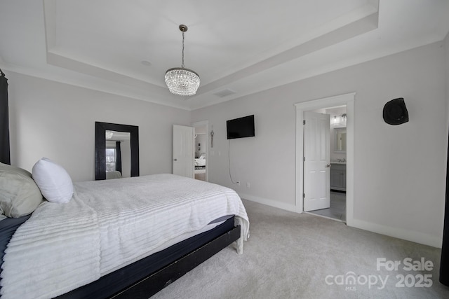 bedroom with carpet floors, a tray ceiling, an inviting chandelier, and baseboards