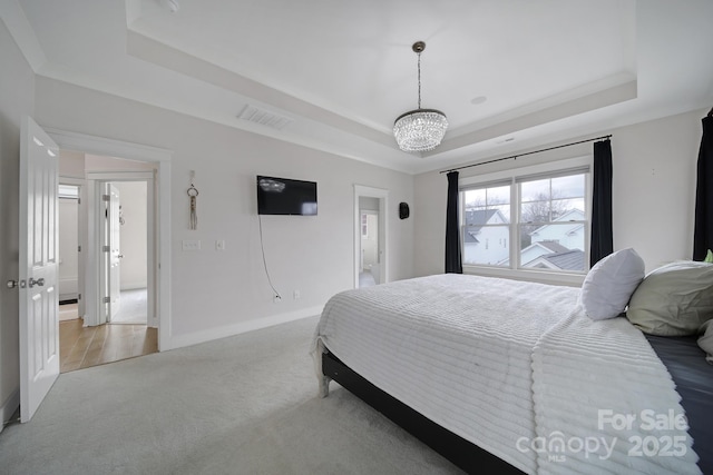 bedroom with a notable chandelier, visible vents, baseboards, carpet, and a raised ceiling