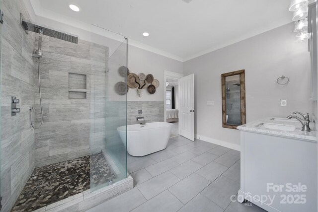 full bathroom with tile walls, vanity, a freestanding bath, tile patterned floors, and a stall shower