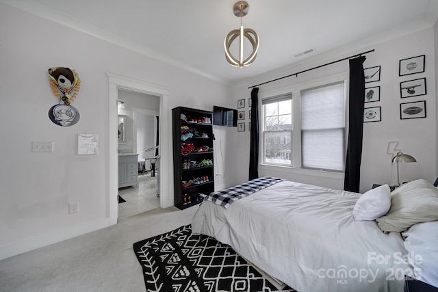 bedroom with carpet floors, visible vents, connected bathroom, and baseboards