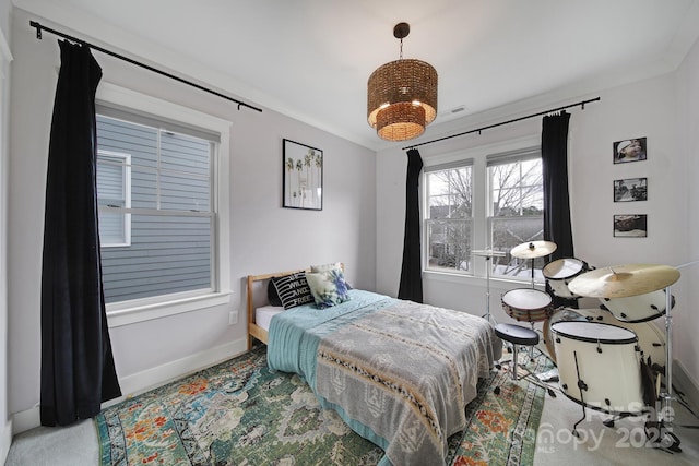 bedroom featuring a notable chandelier and baseboards