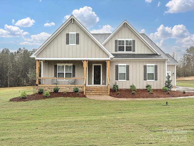 view of front of home with covered porch, a front lawn, and board and batten siding