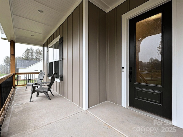 entrance to property featuring covered porch and board and batten siding