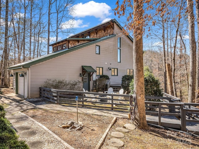 view of side of home with a fenced front yard and a garage