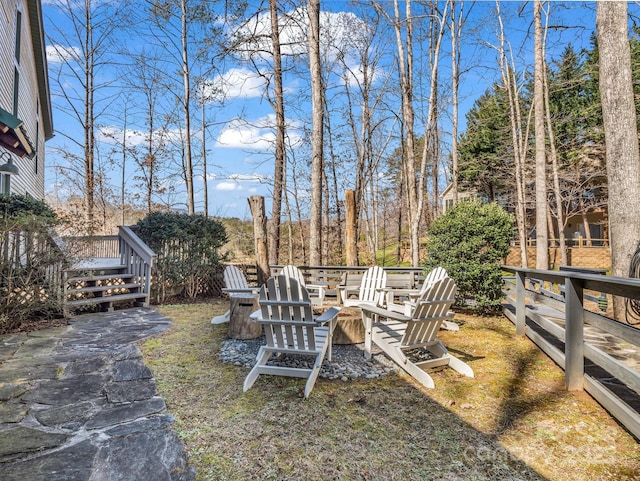 view of yard featuring an outdoor fire pit and a deck