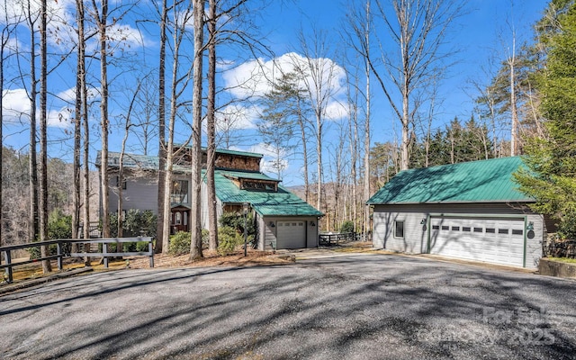 view of front of property with a garage and metal roof