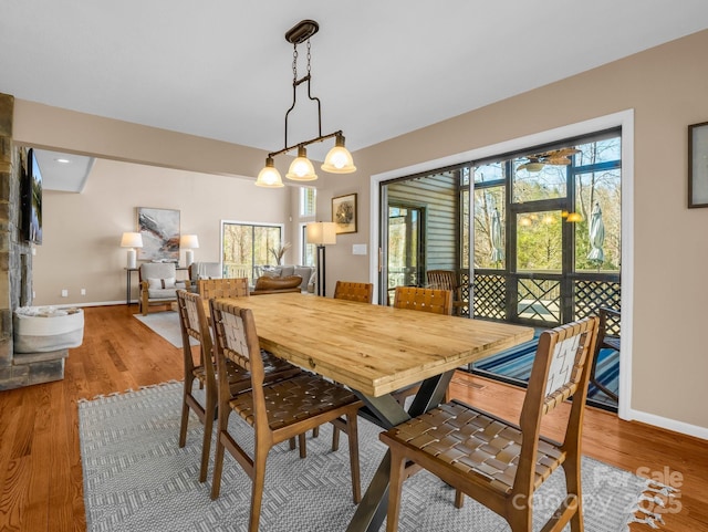 dining space with wood finished floors and baseboards