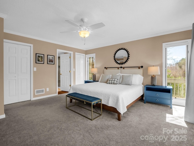 bedroom with baseboards, visible vents, carpet floors, and ornamental molding