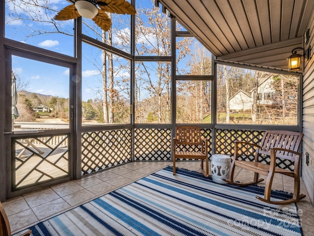 unfurnished sunroom with ceiling fan