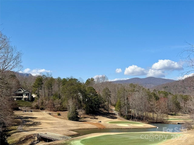 surrounding community featuring a forest view and a water and mountain view