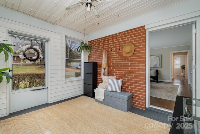 sunroom / solarium featuring ceiling fan