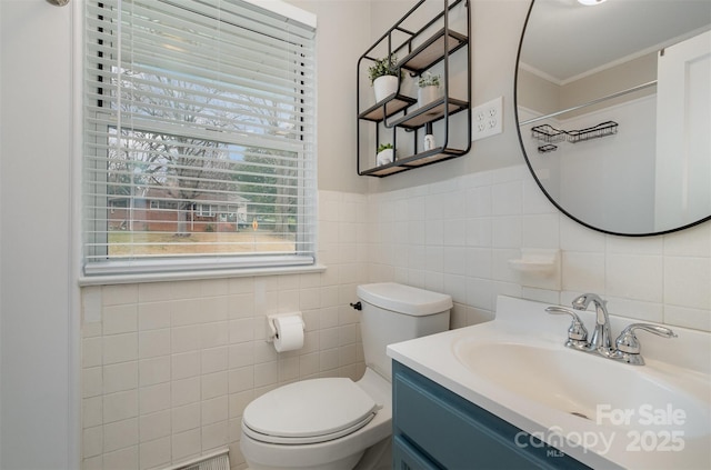 bathroom featuring tile walls, toilet, and vanity