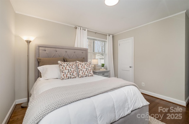 bedroom featuring dark wood-style floors, crown molding, and baseboards