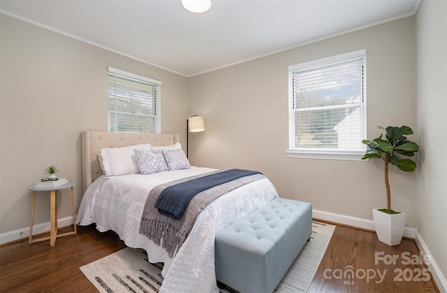 bedroom featuring wood finished floors, baseboards, and ornamental molding