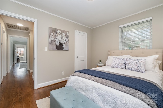 bedroom with baseboards, wood finished floors, visible vents, and ornamental molding