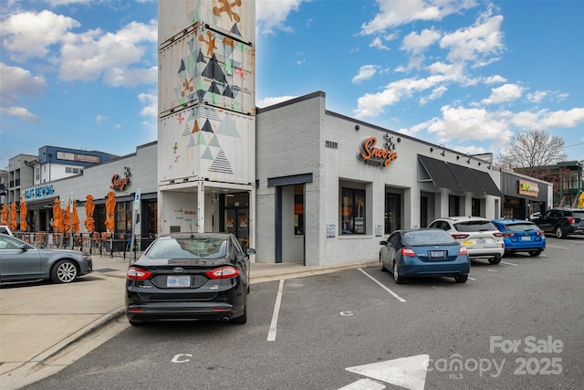 view of property featuring uncovered parking