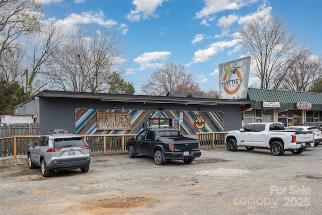 exterior space featuring uncovered parking and fence