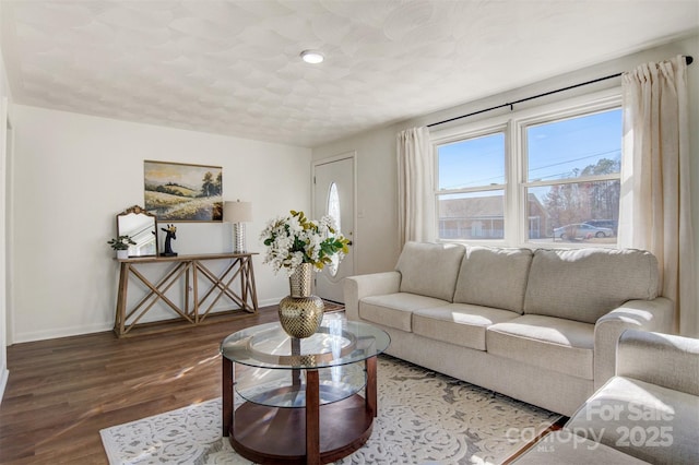 living area featuring wood finished floors and baseboards