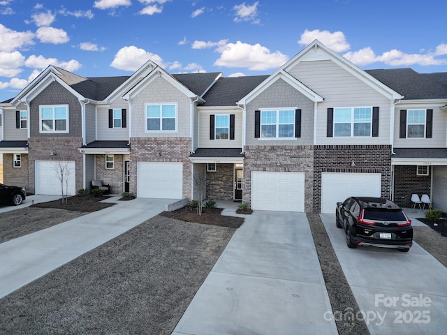 view of front of house with concrete driveway, a garage, and brick siding