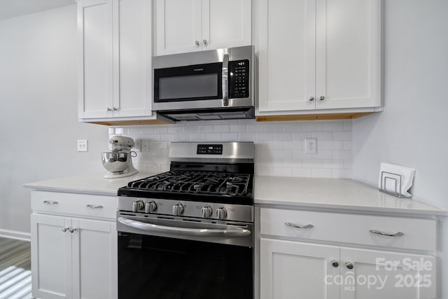 kitchen featuring white cabinetry, tasteful backsplash, and stainless steel appliances