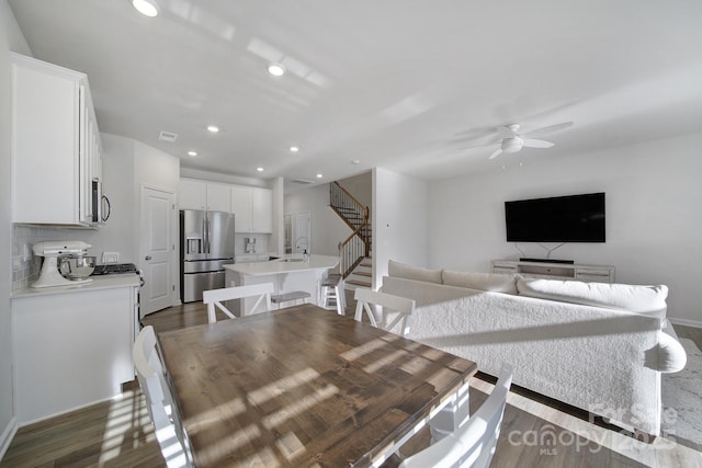 dining room featuring baseboards, recessed lighting, dark wood-style flooring, ceiling fan, and stairs