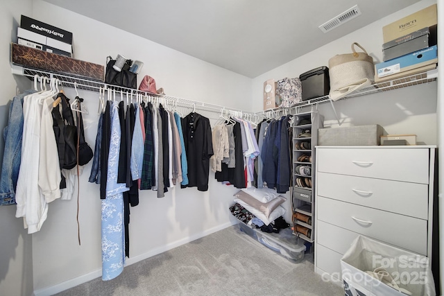 walk in closet featuring visible vents and carpet