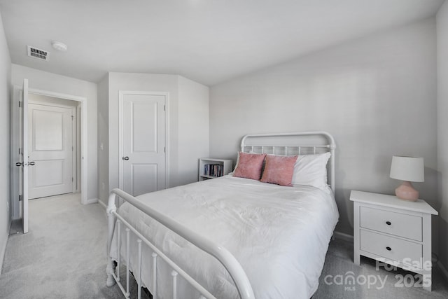 bedroom with light carpet, visible vents, and baseboards