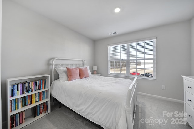 carpeted bedroom with visible vents and baseboards