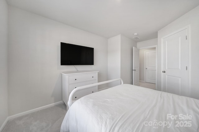 bedroom with carpet and baseboards