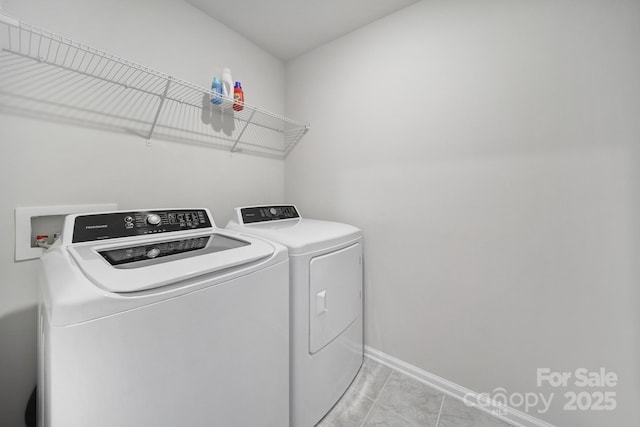 laundry room featuring baseboards, independent washer and dryer, and laundry area