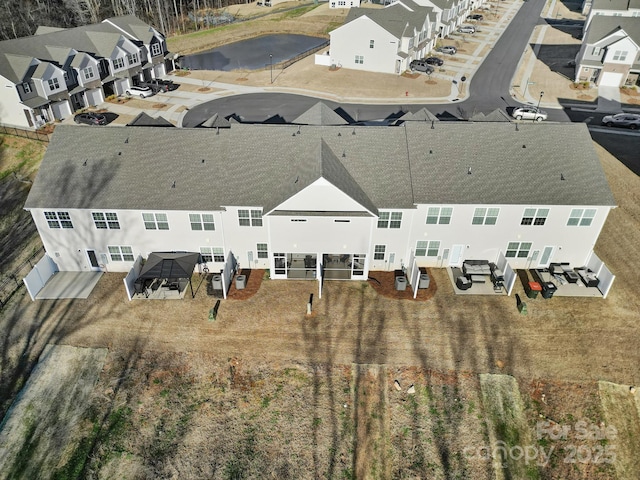 birds eye view of property with a residential view