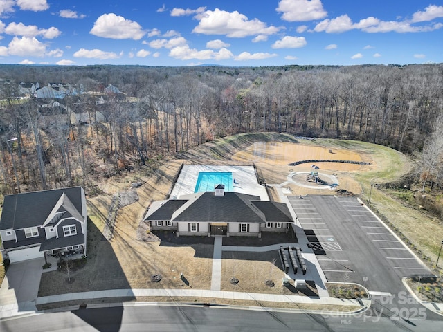 birds eye view of property featuring a view of trees