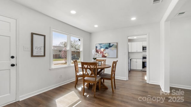 dining area with dark wood-style floors, recessed lighting, visible vents, and baseboards