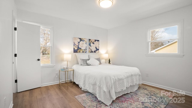 bedroom with wood finished floors and baseboards