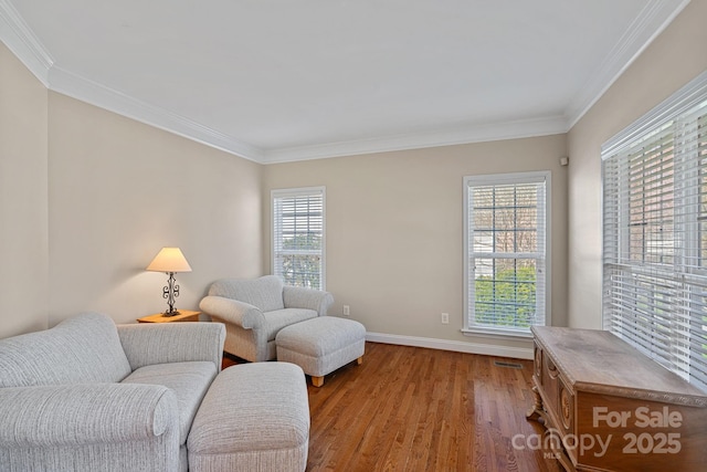 living room featuring ornamental molding, baseboards, plenty of natural light, and wood finished floors