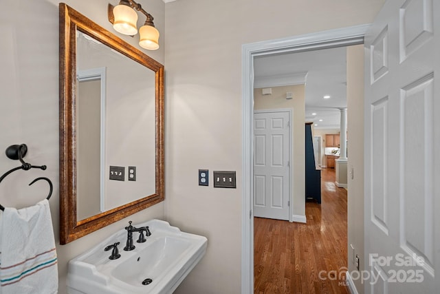 bathroom featuring a sink, recessed lighting, and wood finished floors