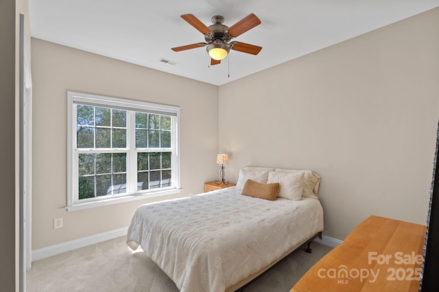 carpeted bedroom featuring ceiling fan, baseboards, and visible vents