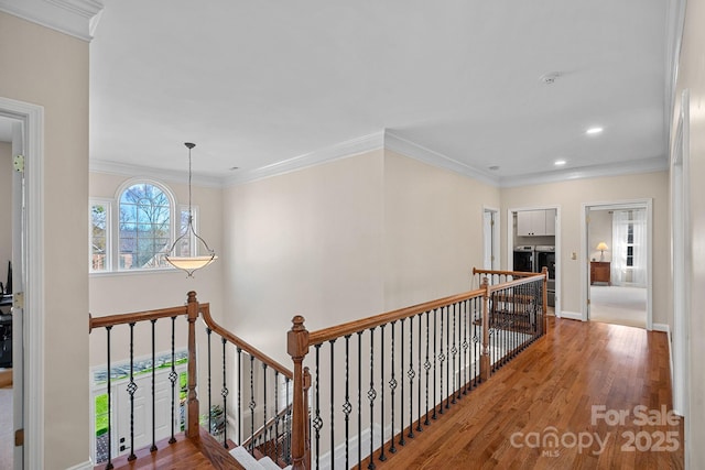 corridor with baseboards, recessed lighting, an upstairs landing, crown molding, and wood finished floors