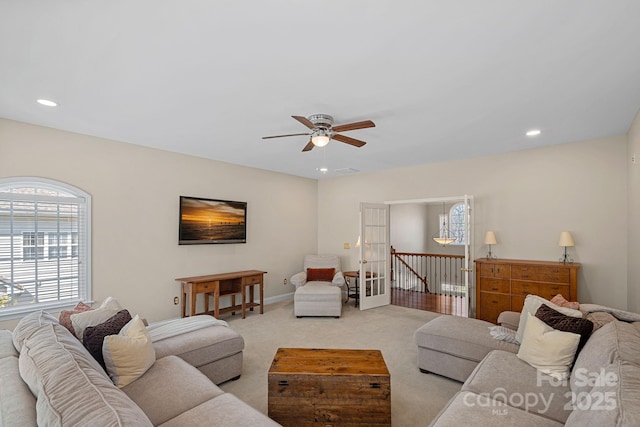 living area featuring recessed lighting, light colored carpet, a ceiling fan, and a wealth of natural light