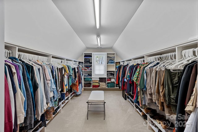 spacious closet with carpet flooring and vaulted ceiling