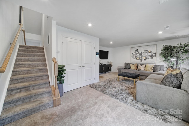 carpeted living room featuring recessed lighting, visible vents, and stairway