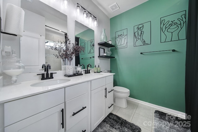 full bathroom featuring toilet, tile patterned flooring, a sink, and a shower stall