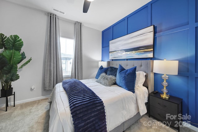 bedroom with carpet floors, baseboards, visible vents, and a ceiling fan