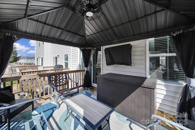 wooden terrace with ceiling fan and a gazebo