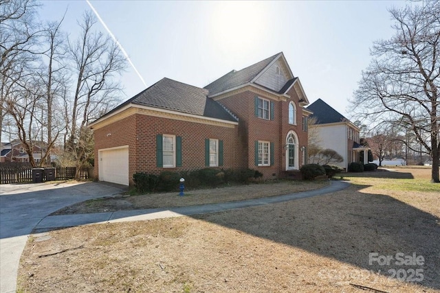 view of front facade with a garage, concrete driveway, brick siding, and fence