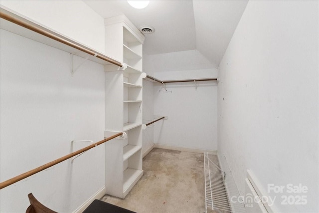 walk in closet with lofted ceiling and visible vents